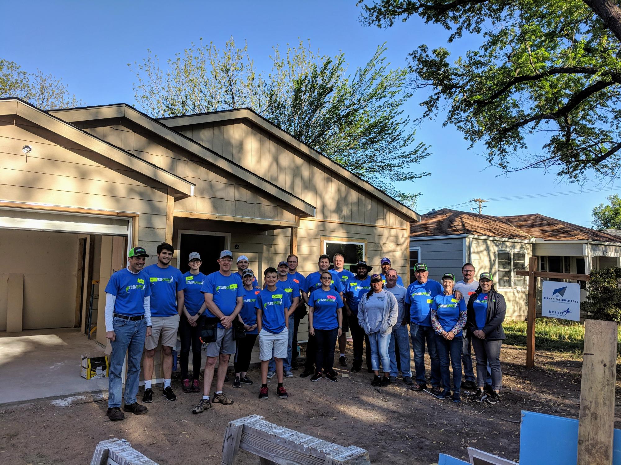 Spirit AeroSystems of Wichita Kansas pose with Tom Gentile and fellow employees at the Habitat for Humanity Air Capital Build in 2019